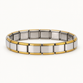 Silver Italian charm bracelet with gold-tone edges on a warm white background