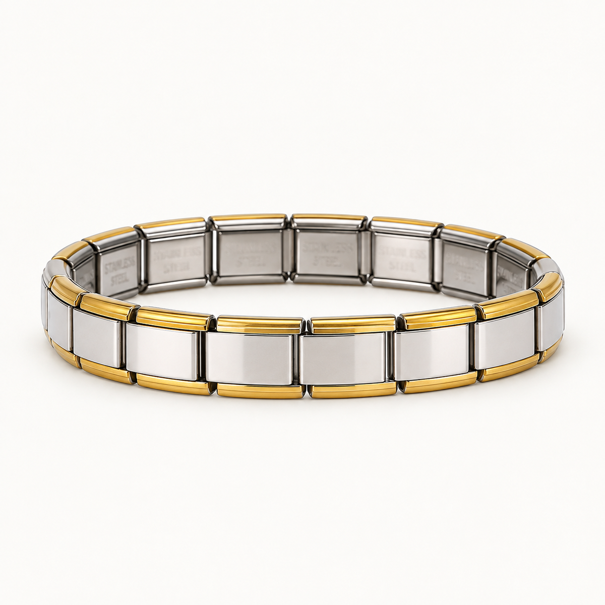 Silver Italian charm bracelet with gold-tone edges on a warm white background